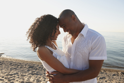 Couple hugging on beach near ocean